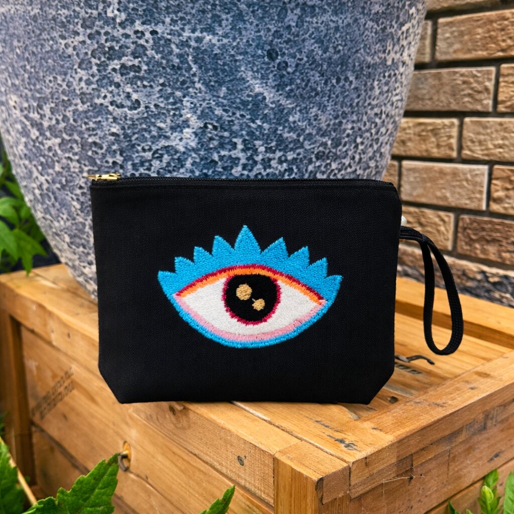 Evil eye punch needle clutch bag with water-resistant lining