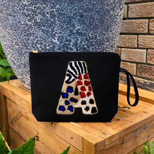 Alphabet punch needle clutch bag with water-resistant lining - A