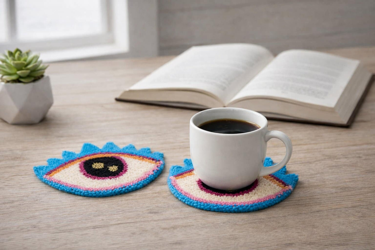 Colorful crocheted coasters with a cup of coffee on a wooden surface.
