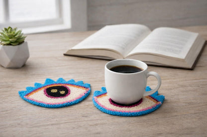 Colorful crocheted coasters with a cup of coffee on a wooden surface.