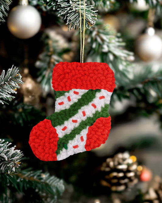 Handmade punch needle Christmas stocking ornament hanging on a decorated Christmas tree - stocking